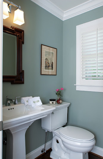 Photo of a small traditional powder room in Atlanta with a pedestal sink, a two-piece toilet and dark hardwood floors.