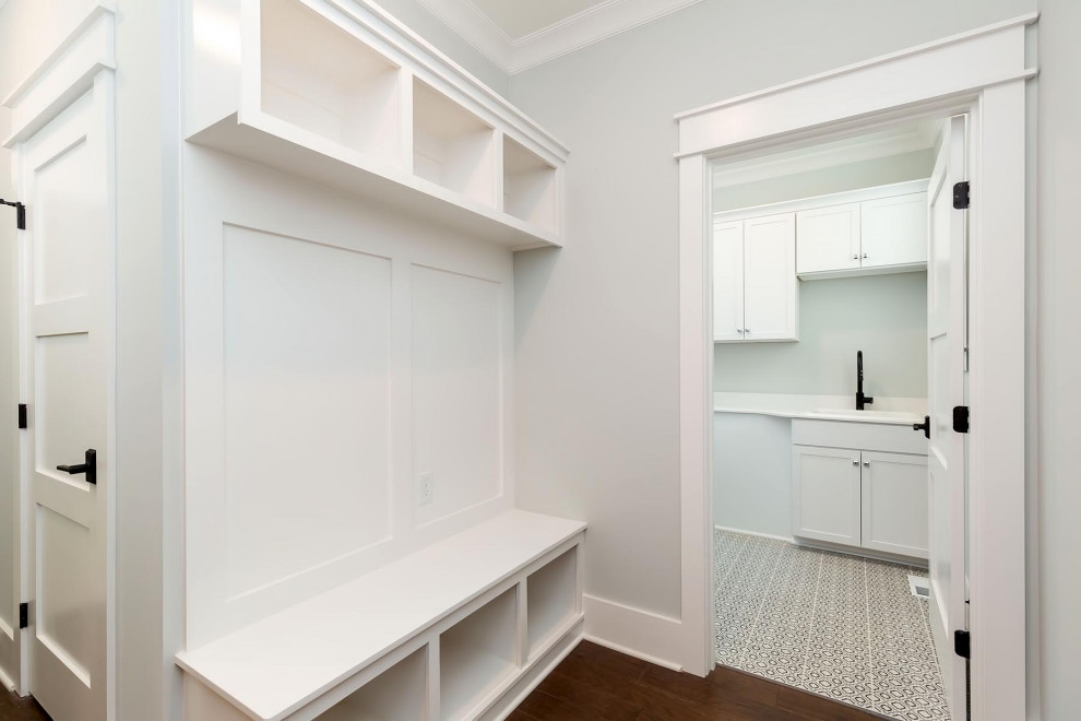 Photo of a small traditional mudroom in Raleigh with grey walls, medium hardwood floors and brown floor.