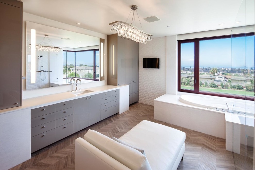 Photo of a mid-sized contemporary master bathroom in San Diego with flat-panel cabinets, an alcove tub, white walls, dark hardwood floors, an undermount sink, quartzite benchtops, brown floor and a hinged shower door.