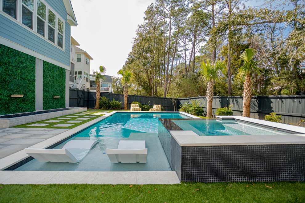 Inspiration for a mid-sized contemporary backyard pool in Charleston with concrete pavers.