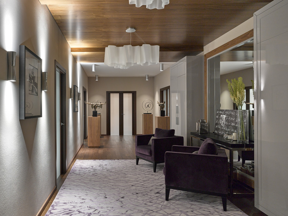 Contemporary hallway in Moscow with beige walls and medium hardwood floors.