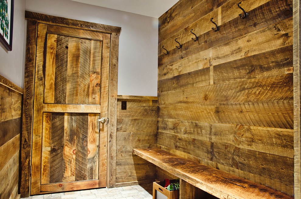 Large mountain style ceramic tile and brown floor mudroom photo with brown walls and a medium wood front door