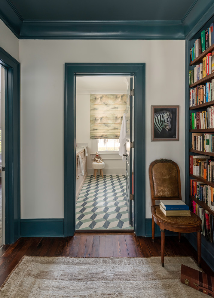 Photo of a mid-sized traditional hallway in Atlanta with white walls, medium hardwood floors and brown floor.