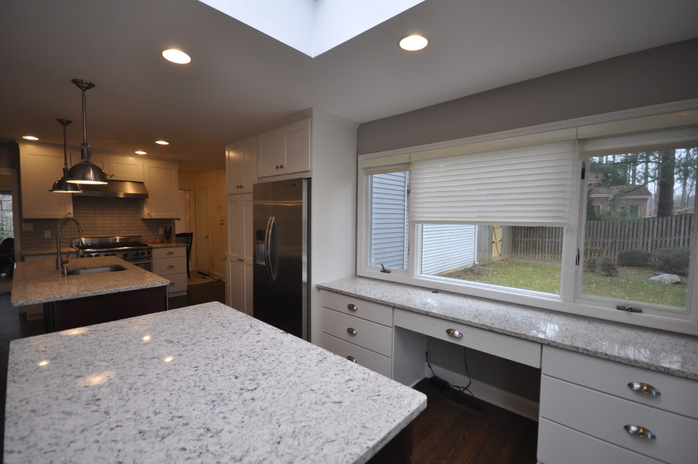 Large transitional u-shaped dark wood floor and brown floor eat-in kitchen photo in DC Metro with an undermount sink, shaker cabinets, white cabinets, green backsplash, subway tile backsplash, stainless steel appliances and an island