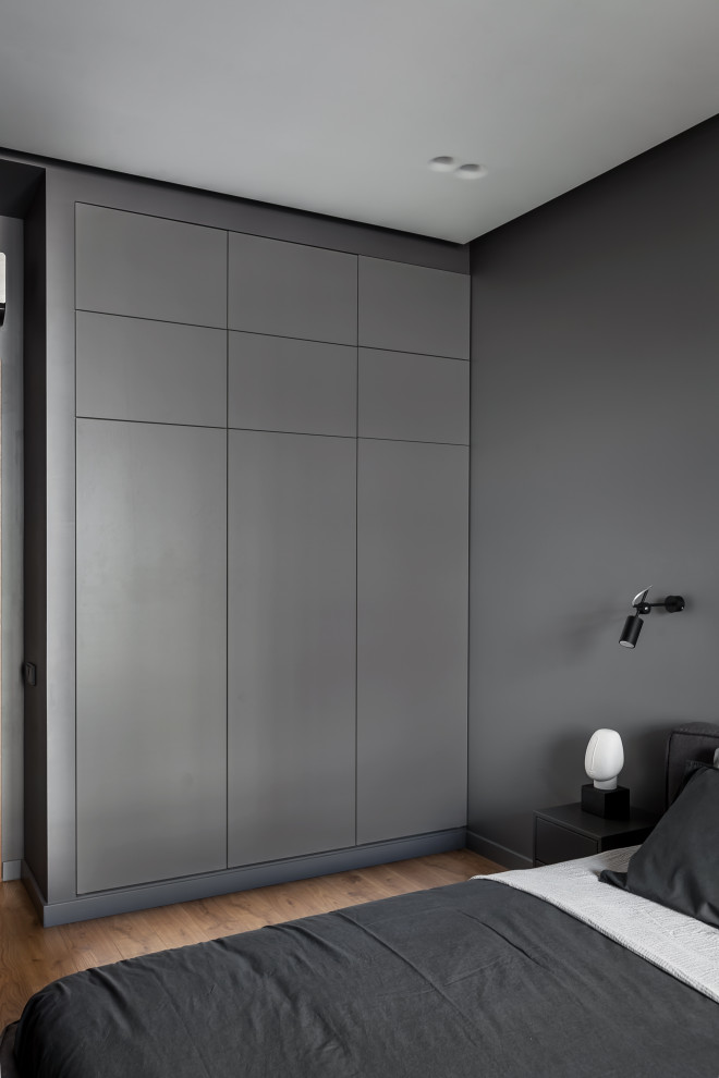 Mid-sized contemporary master bedroom in Moscow with grey walls, laminate floors and beige floor.