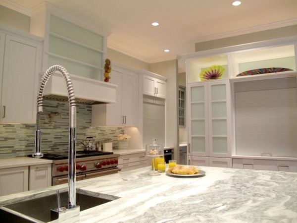 Mid-sized contemporary l-shaped eat-in kitchen in Dallas with a double-bowl sink, glass-front cabinets, white cabinets and stainless steel appliances.