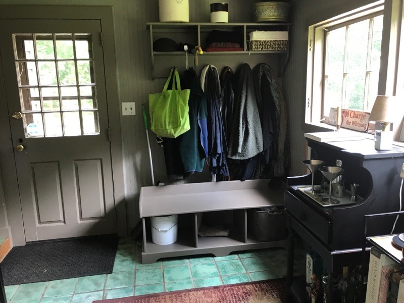 Design ideas for a mid-sized country mudroom in New York with grey walls, ceramic floors, a single front door, a gray front door and green floor.