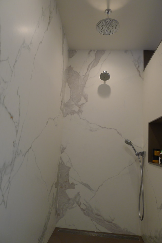 Example of a large transitional master gray tile and porcelain tile porcelain tile home design design in Indianapolis with a drop-in sink, furniture-like cabinets, dark wood cabinets, solid surface countertops, a one-piece toilet and gray walls