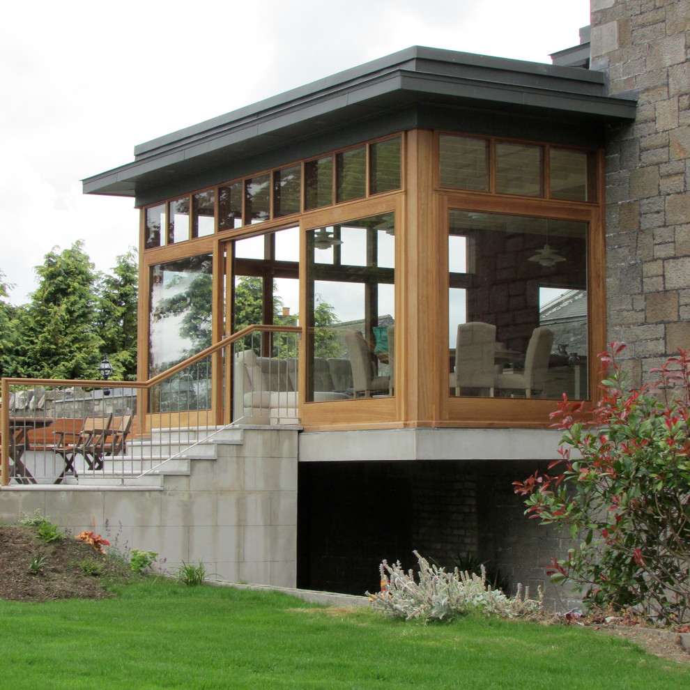 Inspiration for a large contemporary one-storey exterior in Dublin with mixed siding and a flat roof.