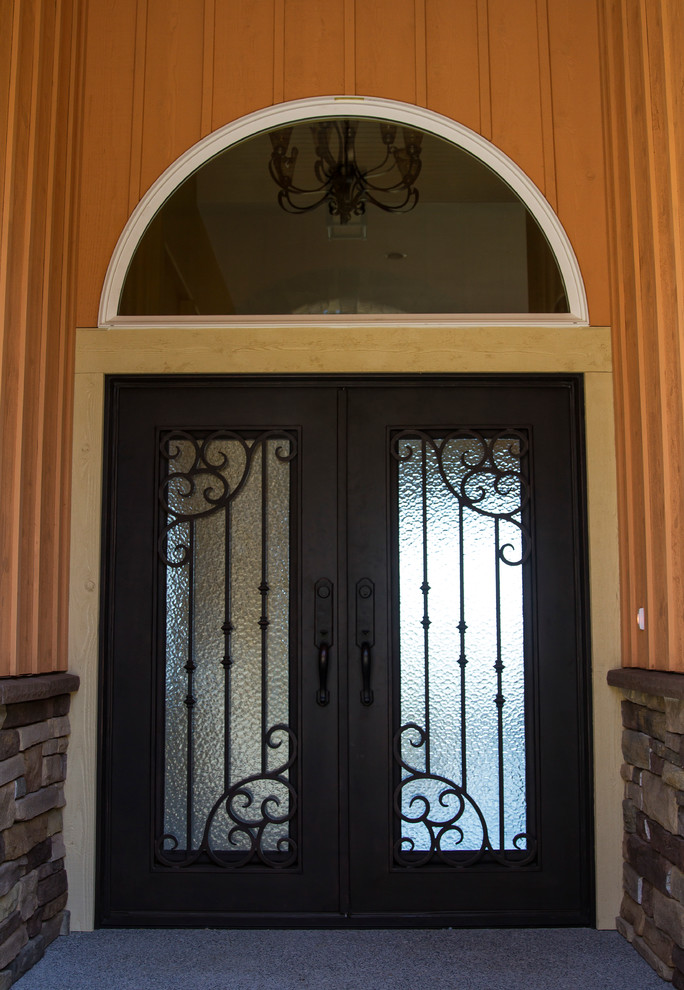 Inspiration for a large modern concrete floor front door remodel in Seattle with beige walls and a metal front door
