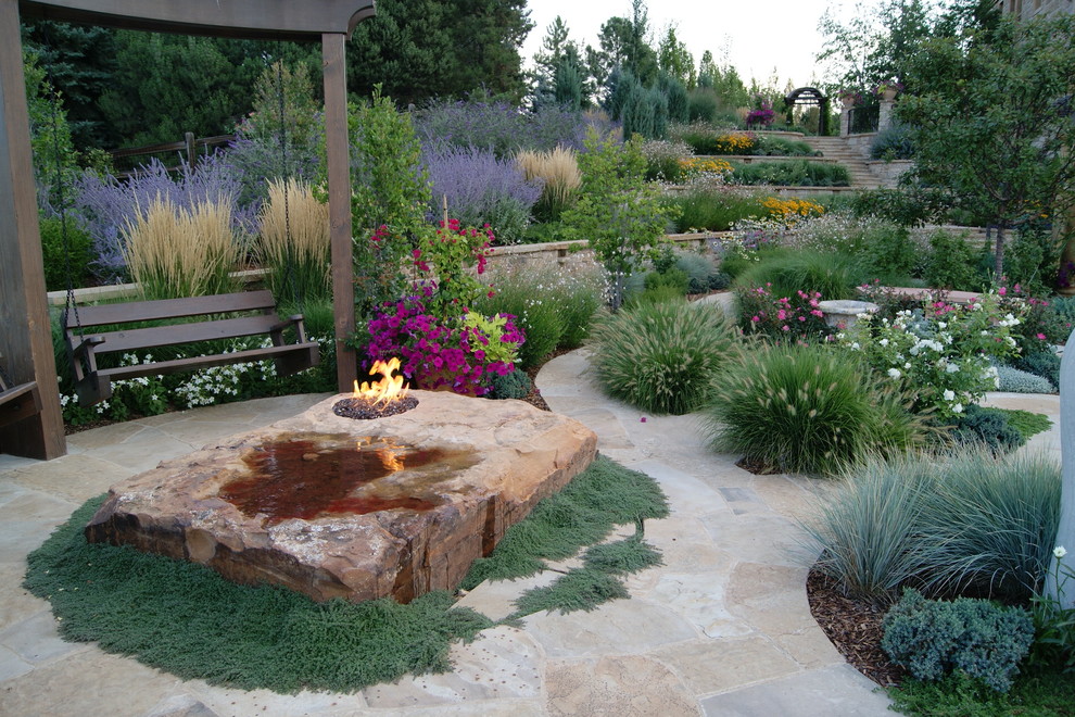Design ideas for a mediterranean backyard garden in Denver with a fire feature.