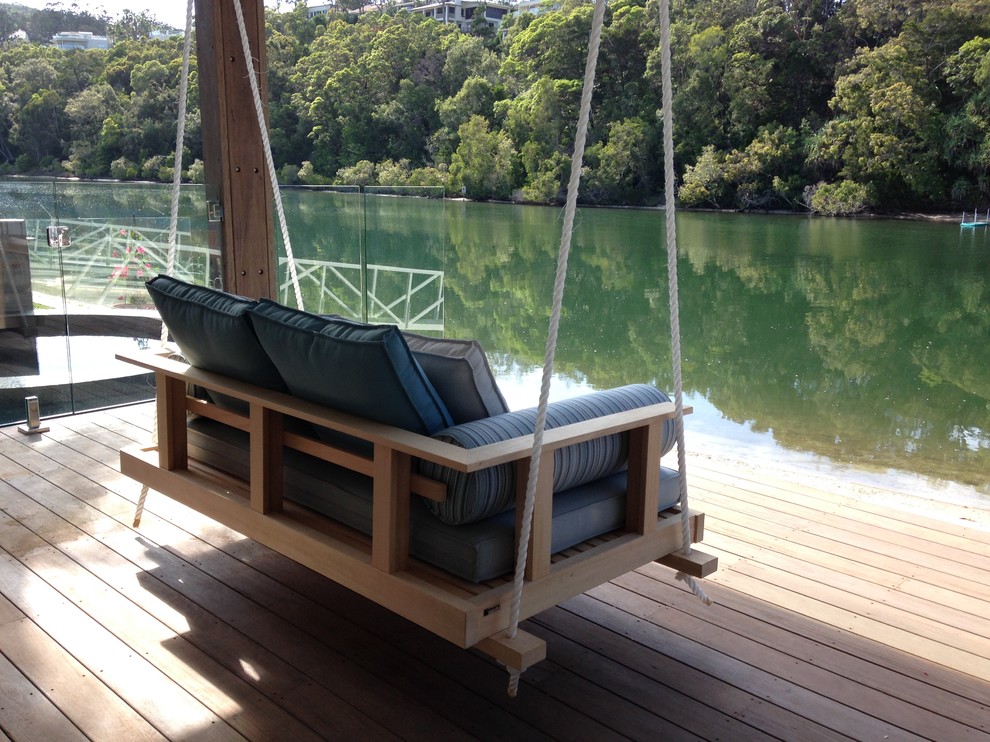 Photo of a beach style backyard patio in Sunshine Coast with a container garden, decking and a pergola.