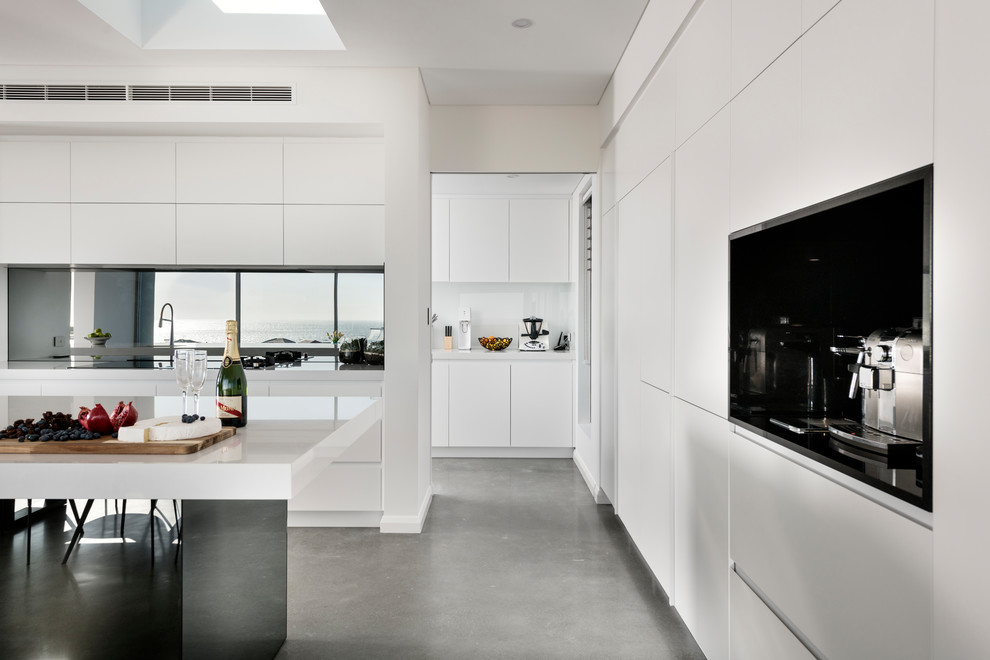Design ideas for a large modern open plan kitchen in Perth with solid surface benchtops, mirror splashback, concrete floors and grey floor.