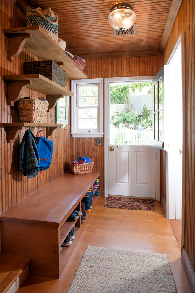 Design ideas for a mid-sized country mudroom in Los Angeles with medium hardwood floors, a dutch front door and a white front door.