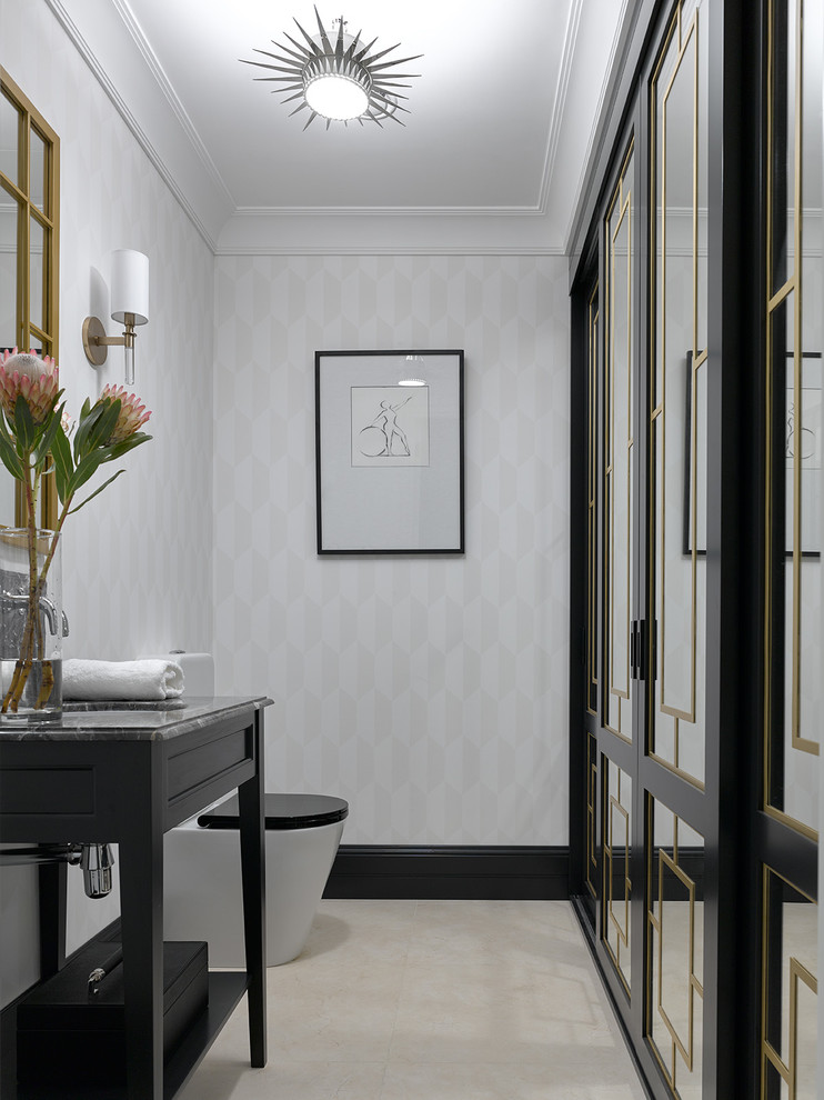 This is an example of a mid-sized transitional powder room in Moscow with black cabinets, a two-piece toilet, porcelain floors, an undermount sink, marble benchtops, beige floor and gray tile.