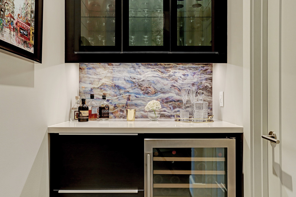 Mid-sized contemporary single-wall home bar in Houston with no sink, glass-front cabinets, black cabinets, quartz benchtops, multi-coloured splashback, stone slab splashback and white benchtop.