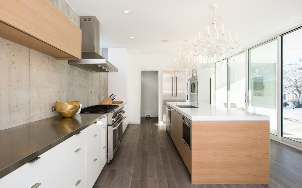 Design ideas for a mid-sized contemporary l-shaped eat-in kitchen in Minneapolis with a single-bowl sink, flat-panel cabinets, light wood cabinets, stainless steel benchtops, stainless steel appliances, dark hardwood floors, with island and cement tile splashback.