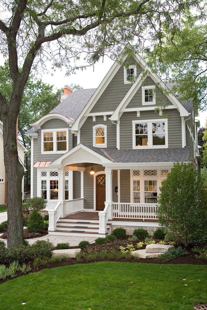 Inspiration for a traditional two-storey grey exterior in Chicago with wood siding and a gable roof.