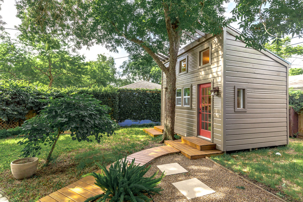 Inspiration for a small transitional built-in desk and detached laminate floor and brown floor studio / workshop shed remodel with white walls and a corner fireplace