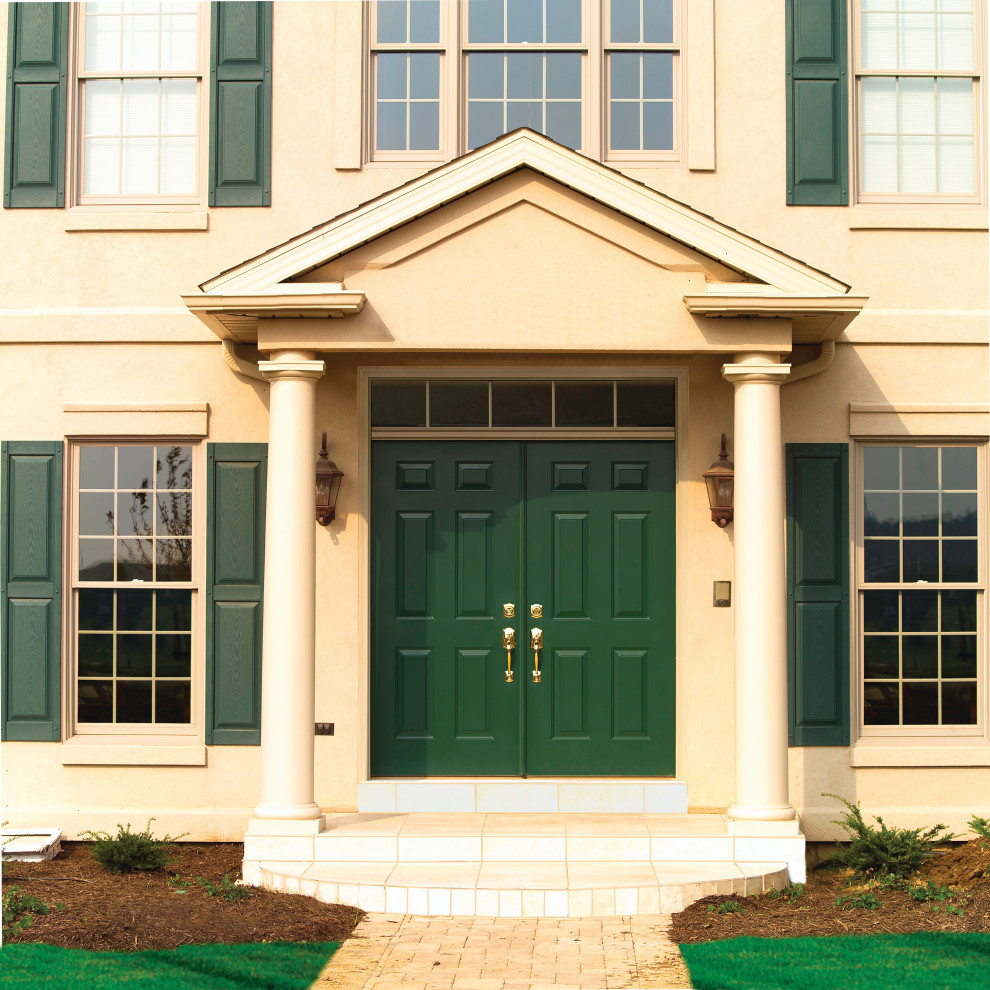 This is an example of a mid-sized traditional front door in Detroit with a double front door and a green front door.