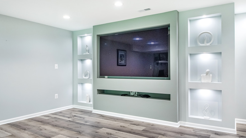 This is an example of a mid-sized transitional walk-out basement in DC Metro with a home bar, grey walls, vinyl floors, no fireplace and grey floor.