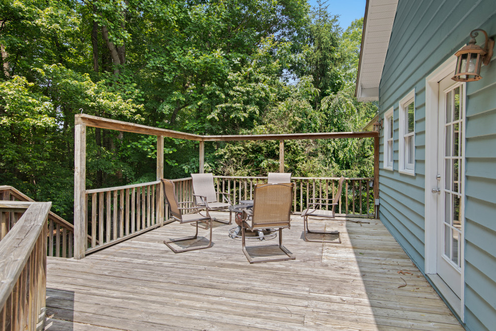 Inspiration for a mid-sized transitional backyard second story wood railing deck remodel with a fire pit and no cover