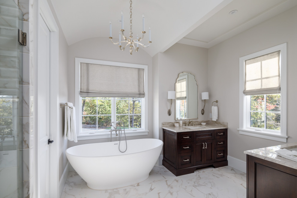Inspiration for a medium sized classic bathroom in Other with dark wood cabinets, a freestanding bath, a built-in shower, a one-piece toilet, white tiles, porcelain tiles, grey walls, porcelain flooring, a submerged sink, marble worktops, white floors, an open shower, grey worktops, double sinks and a vaulted ceiling.