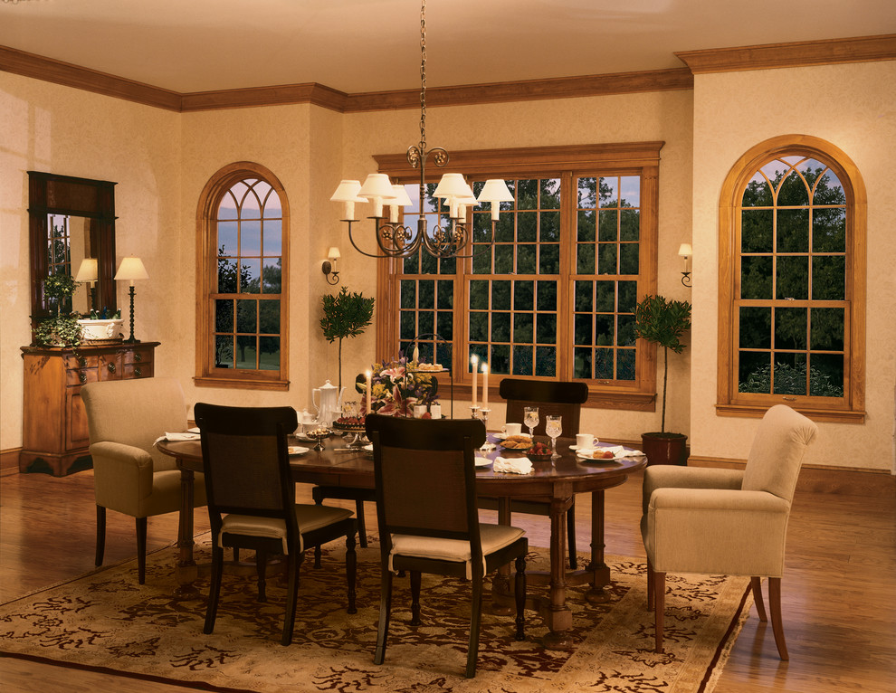 Inspiration for a large traditional open plan dining in Minneapolis with beige walls, light hardwood floors and no fireplace.