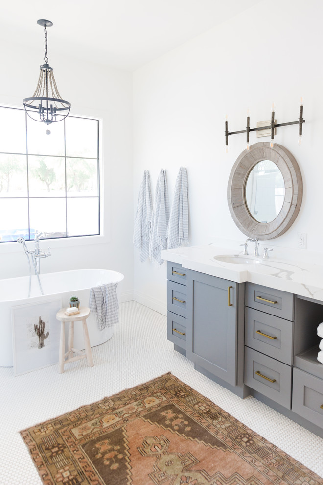 This is an example of a large country master bathroom in Phoenix with shaker cabinets, grey cabinets, a freestanding tub, white walls, mosaic tile floors, an undermount sink, quartzite benchtops, white floor and white benchtops.