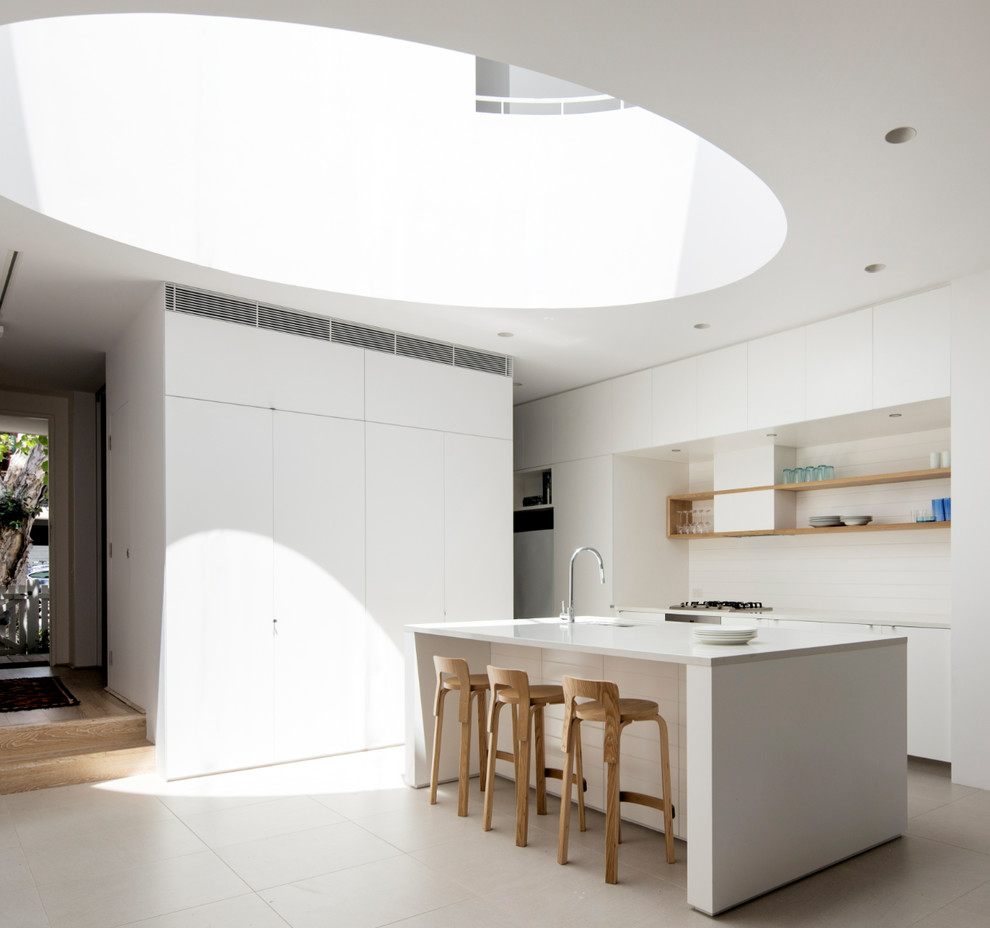 Contemporary kitchen in Sydney with flat-panel cabinets, white cabinets and with island.