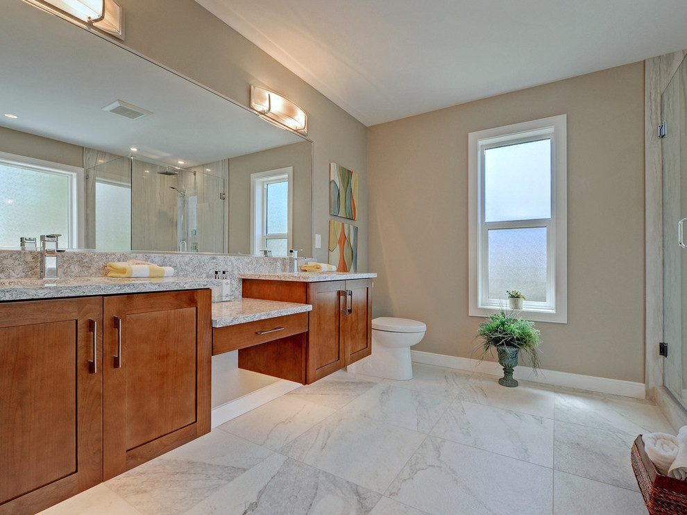 Large contemporary master bathroom in Vancouver with shaker cabinets, medium wood cabinets, white tile, stone tile, engineered quartz benchtops, an alcove shower, a one-piece toilet, beige walls, marble floors, an undermount sink, white floor and a hinged shower door.