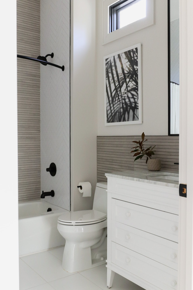 Inspiration for a small modern bathroom in Birmingham with shaker cabinets, white cabinets, an alcove tub, a shower/bathtub combo, a one-piece toilet, porcelain floors, an undermount sink, marble benchtops, white floor, a shower curtain, a single vanity and a freestanding vanity.