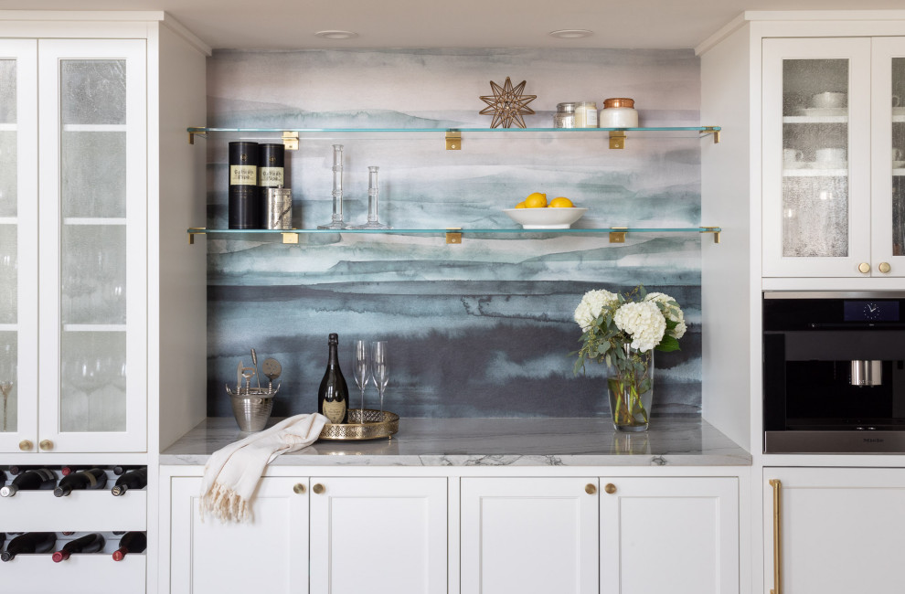 Photo of a small transitional single-wall home bar in New York with shaker cabinets, white cabinets, quartzite benchtops, blue splashback and grey benchtop.
