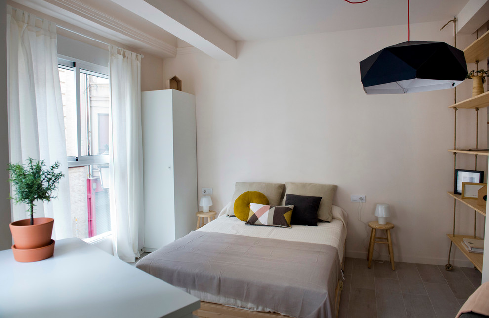 Small mediterranean open concept living room in Valencia with beige walls, ceramic floors and beige floor.