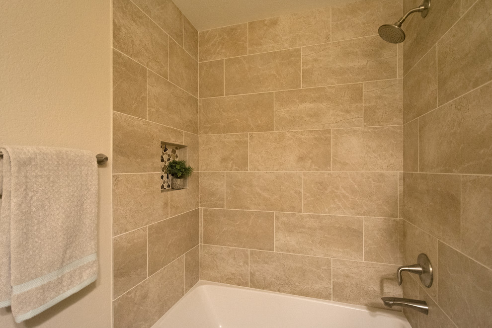 Inspiration for a mid-sized traditional kids bathroom in Phoenix with a drop-in tub, beige tile, porcelain tile, beige walls, porcelain floors, beige floor, a shower curtain, raised-panel cabinets, dark wood cabinets, a shower/bathtub combo, a two-piece toilet, an undermount sink and engineered quartz benchtops.