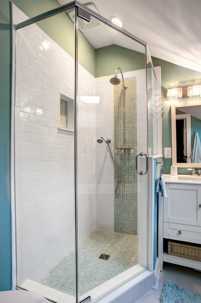 This is an example of a mid-sized traditional master bathroom with shaker cabinets, white cabinets, a corner tub, a corner shower, a one-piece toilet, white tile, subway tile, green walls, ceramic floors, an undermount sink, engineered quartz benchtops, beige floor and a hinged shower door.
