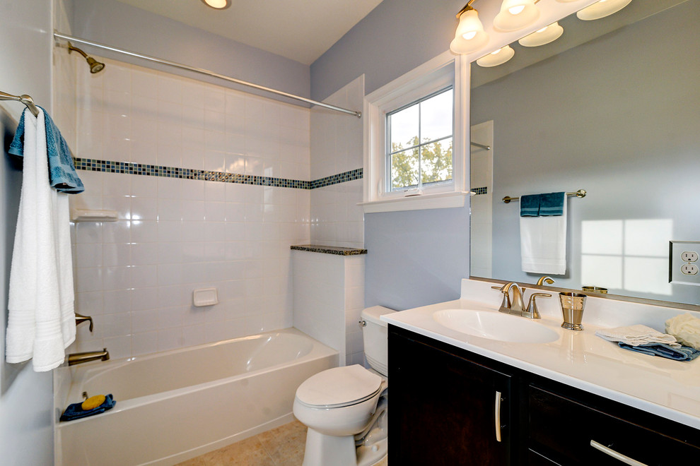 Photo of a transitional master bathroom in DC Metro with an undermount sink, recessed-panel cabinets, dark wood cabinets, a drop-in tub, an alcove shower, white tile, subway tile, purple walls and porcelain floors.