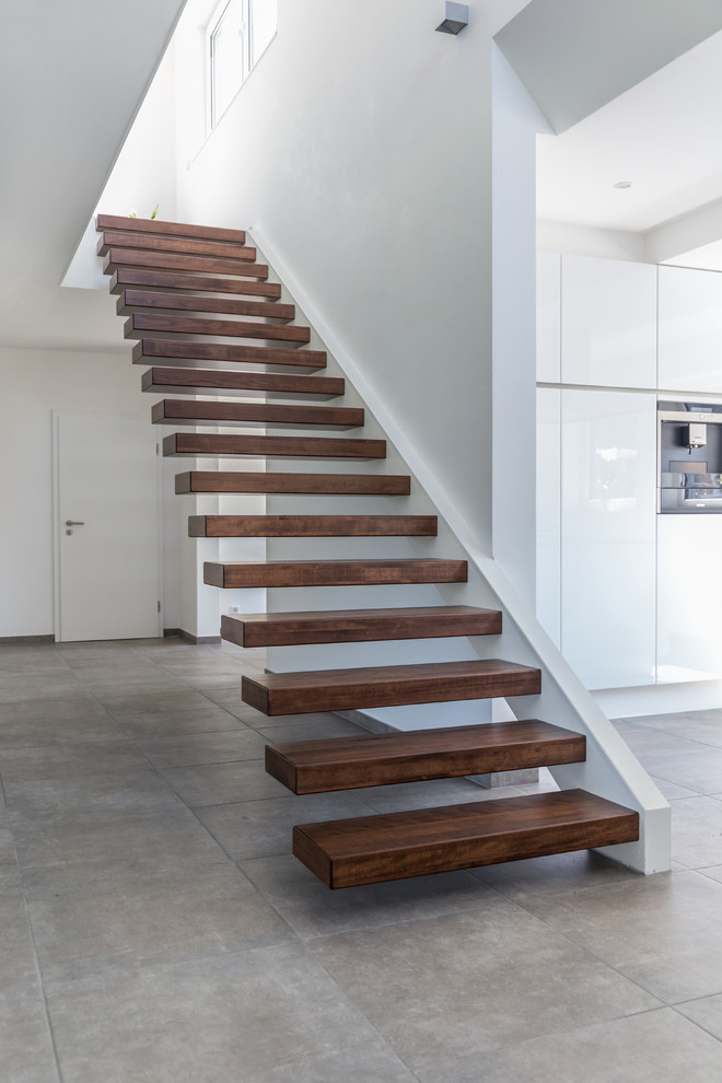 Inspiration for a large contemporary wood floating staircase in Dusseldorf with open risers.