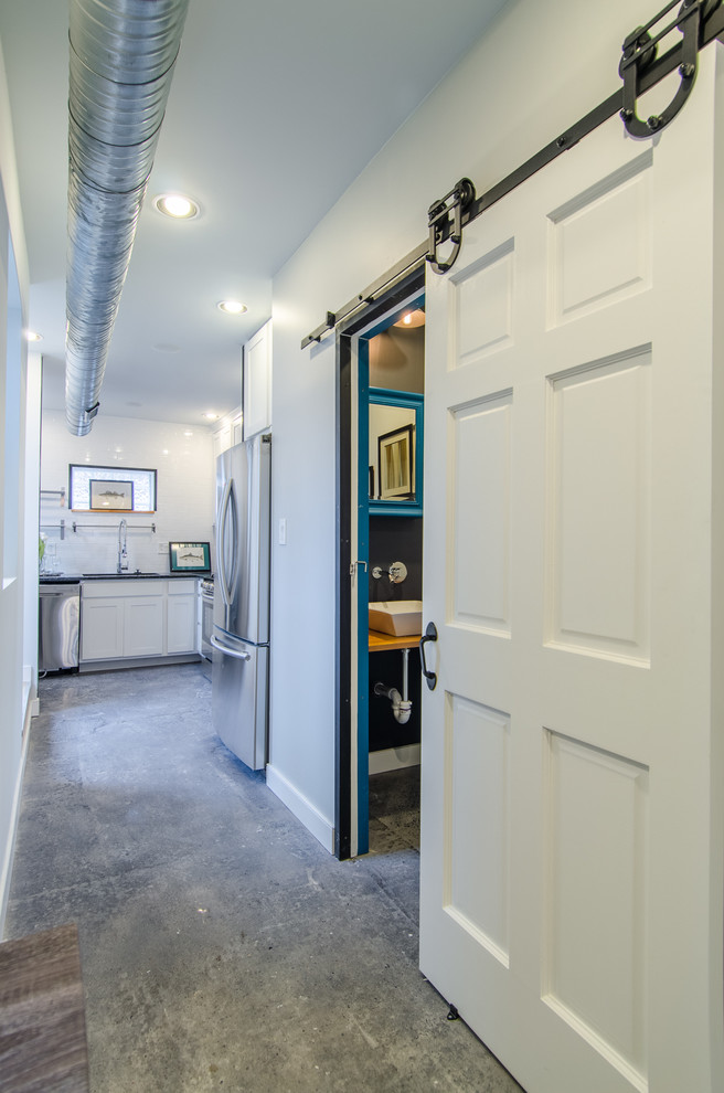 Large transitional concrete floor and gray floor hallway photo in Baltimore with gray walls