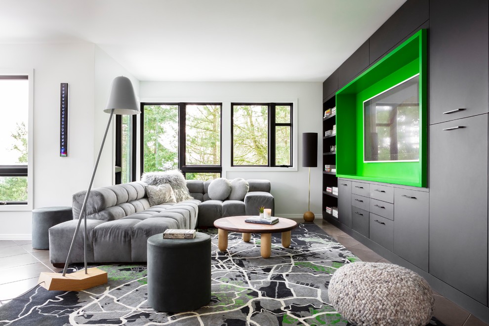 Inspiration for a large contemporary open concept family room in Portland with green walls, porcelain floors, a wall-mounted tv, grey floor and no fireplace.