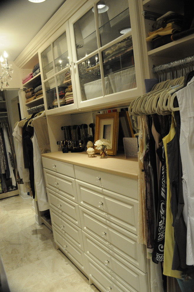 Photo of a large traditional gender-neutral walk-in wardrobe in Philadelphia with raised-panel cabinets and beige cabinets.