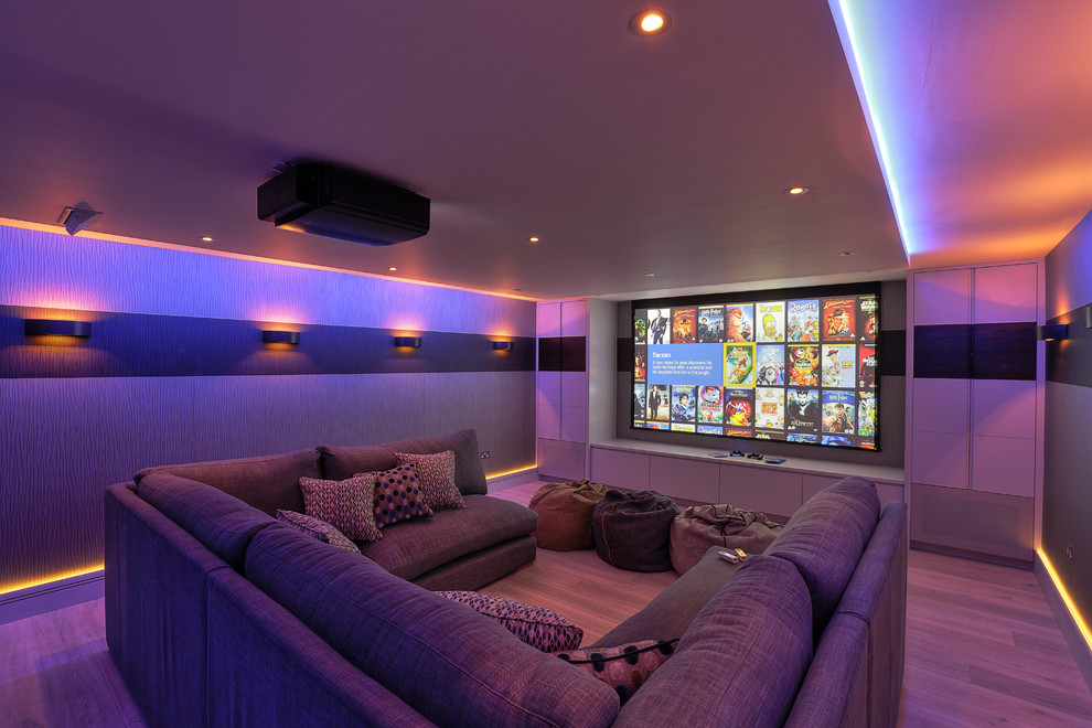 Design ideas for a contemporary enclosed home theatre in Kent with a projector screen.