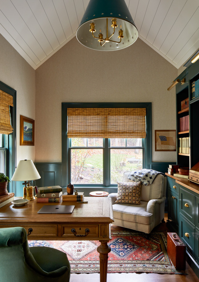 This is an example of a medium sized farmhouse study in Boston with beige walls, medium hardwood flooring, a freestanding desk, a timber clad ceiling and wainscoting.