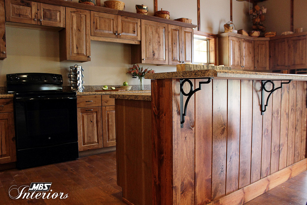 Kitchen - rustic l-shaped kitchen idea in Columbus with recessed-panel cabinets, medium tone wood cabinets, laminate countertops and black appliances