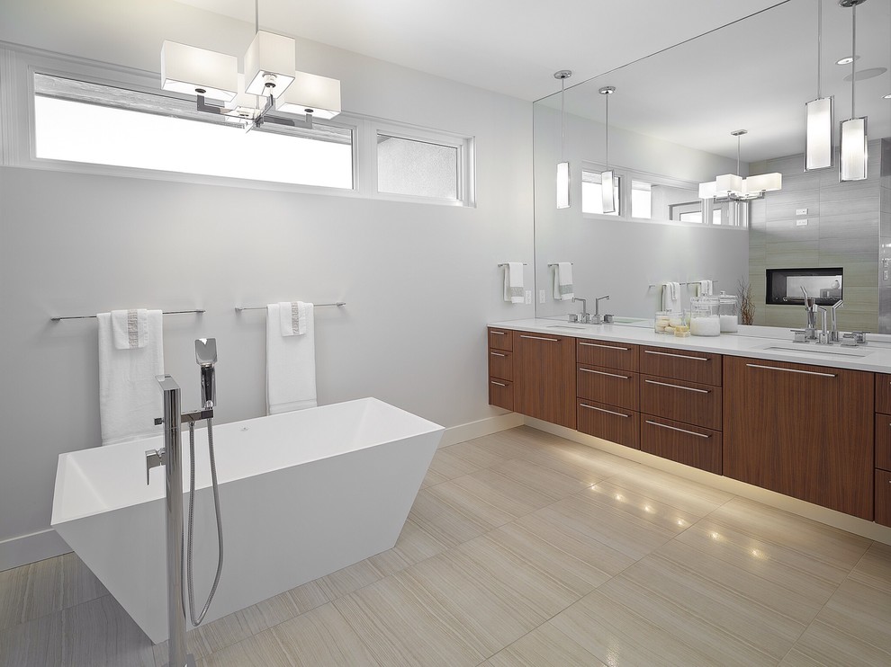 This is an example of a large contemporary master bathroom in Edmonton with an undermount sink, flat-panel cabinets, a freestanding tub, grey walls, medium wood cabinets, a corner shower, a one-piece toilet, beige tile, porcelain tile, porcelain floors and engineered quartz benchtops.