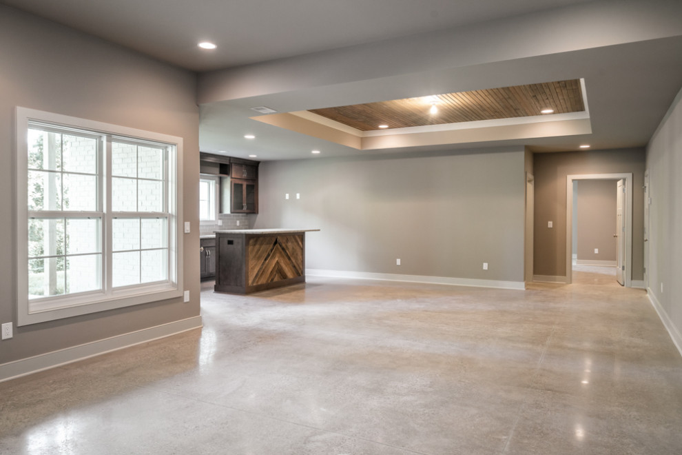Inspiration for a walk-out basement in Louisville with a home bar, grey walls, concrete floors, grey floor and wood.