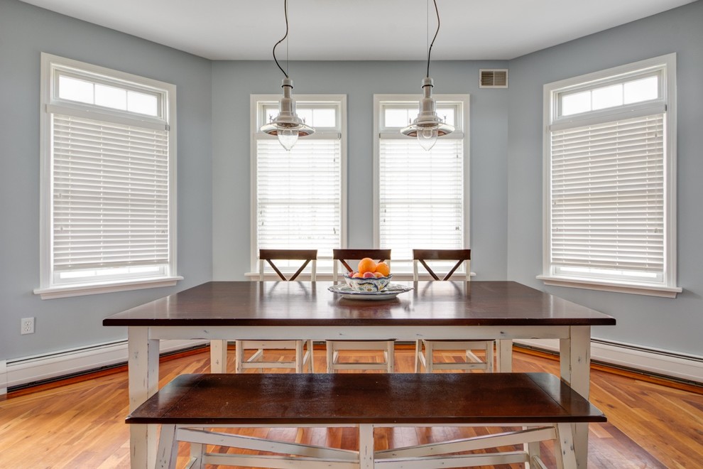 This is an example of a traditional dining room in New York with grey walls.