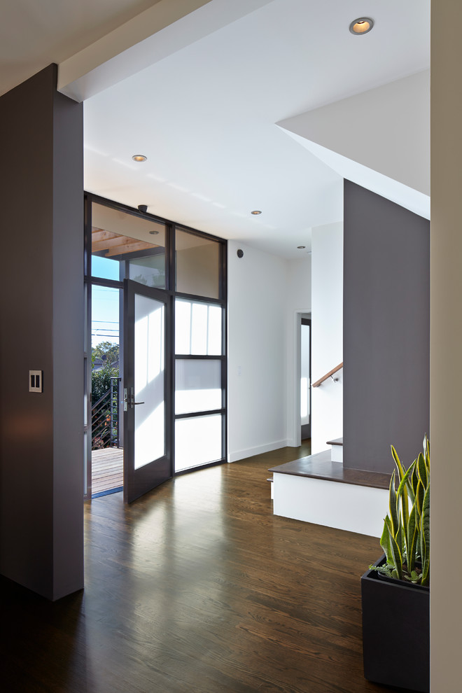 Contemporary foyer in San Francisco with black walls, dark hardwood floors, a single front door and a black front door.