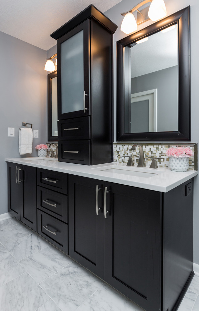 Mid-sized transitional master gray tile and mosaic tile marble floor walk-in shower photo with an undermount sink, recessed-panel cabinets, dark wood cabinets, quartzite countertops, a one-piece toilet and gray walls