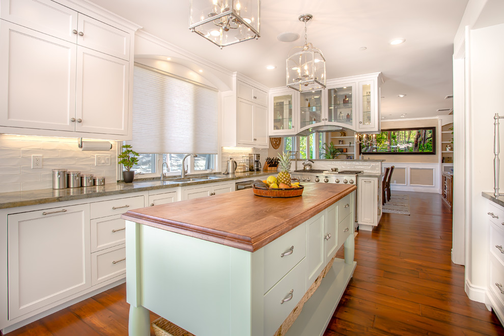 Photo of a beach style kitchen in San Diego with shaker cabinets and with island.